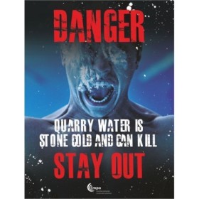 Danger sign warning quarry water is stone cold and can kill with stay out message